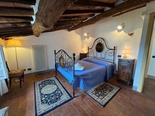 a bedroom with a bed with a blue comforter at Casa Max in Capannori