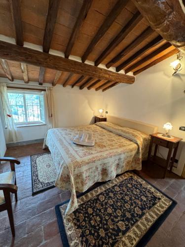 a bedroom with a bed in a room with wooden ceilings at Casa Max in Capannori