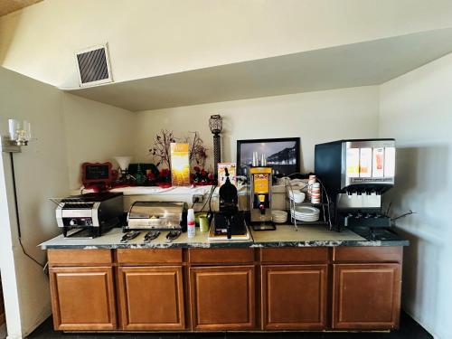 a kitchen with a counter top with many items on it at Quality Inn in Sarnia