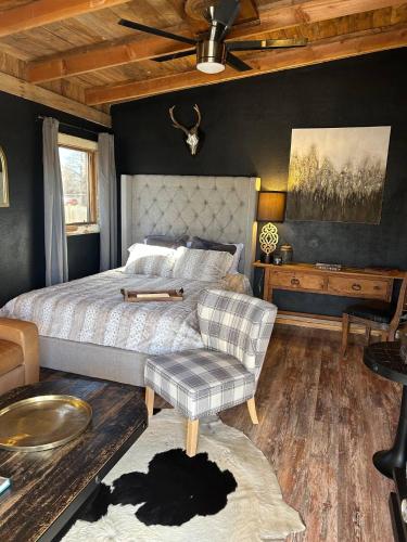 a bedroom with a bed and a ceiling fan at River View, Red River Carriage House in Shreveport