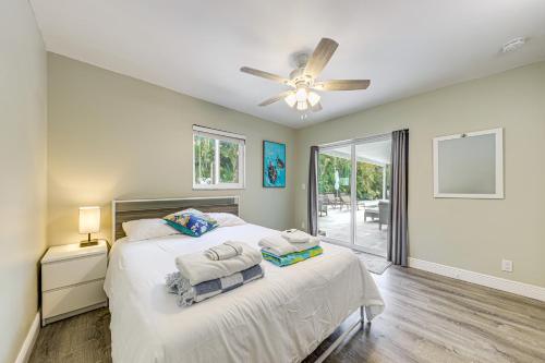 a bedroom with a bed and a ceiling fan at 2 Mi to Deerfield Beach Home with Outdoor Oasis! in Deerfield Beach