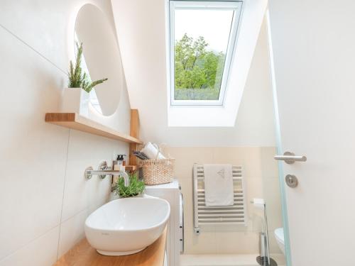 a bathroom with a white sink and a window at Residence Soča in Soča