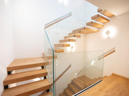 a staircase in a house with glass railing at Residence Soča in Soča