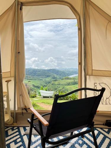 a black chair sitting in front of a window at Papa Garden Khaokho in Khao Kho
