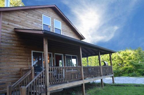 a log cabin with a porch and a deck at Goldies Hideaway in Bryson City