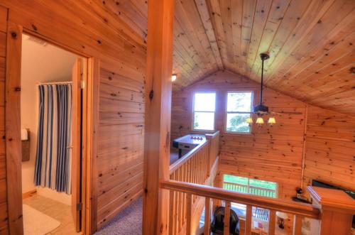 a log cabin with a staircase and a window at Goldies Hideaway in Bryson City