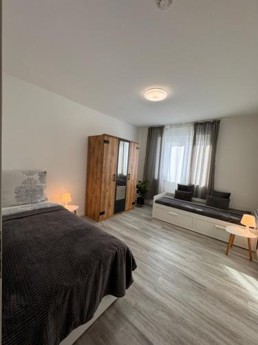 a bedroom with a bed and a bench in a room at Apartment Künzelsau II in Künzelsau