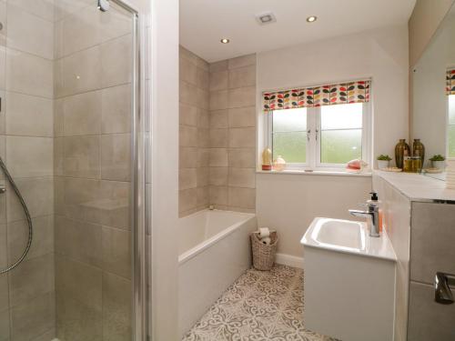 a bathroom with a shower and a sink at Knoll View in Bradwell