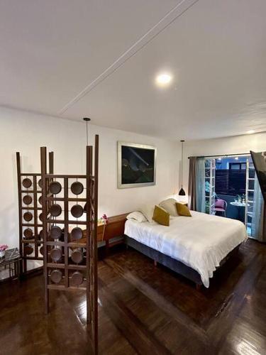 a bedroom with a bed and a wine rack at Deco House with Park View Rooftop in Mexico City