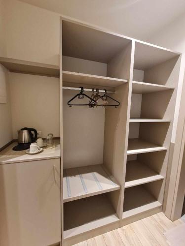 a cupboard with empty shelves in a kitchen at Olympus Thea in Litochoro