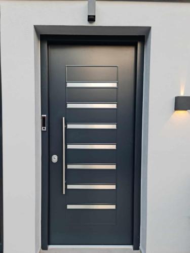 a black door with a silver handle on a wall at Olympus Thea in Litochoro