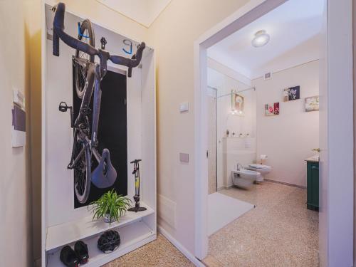 a bathroom with a closet with a bike rack at Marilla Apartment in Capannori