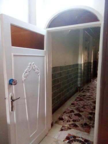 a white door with a handle in a bathroom at Nubian Life Nile View in Aswan