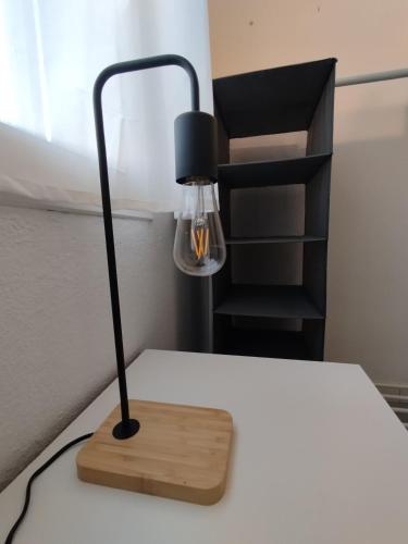a black lamp sitting on top of a bed at Casa Adosada Mirador de Sevilla in Tomares