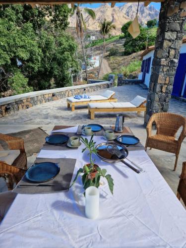 a table with a white table cloth and blue plates at Casa Saúde in Seladinha