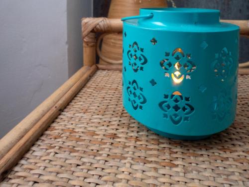 a blue pot sitting on a wicker basket at Entire 5 Bedroom Comfortable House in Eastbourne in Eastbourne