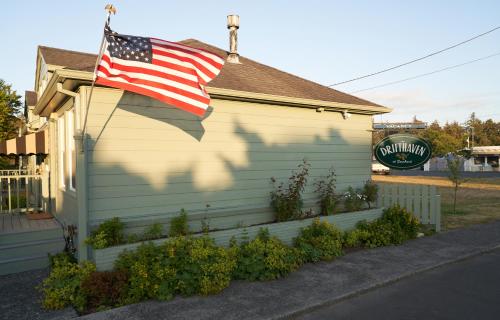 an american flag hanging on the side of a house at The Drifthaven at Gearhart in Gearhart