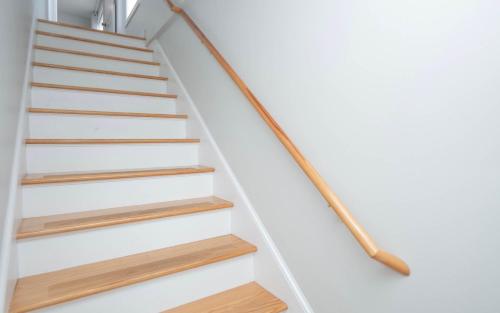a staircase with wooden treads in a house at Jennifer's Penthouse 2 Floor Apartment - Amazing City View in Providence