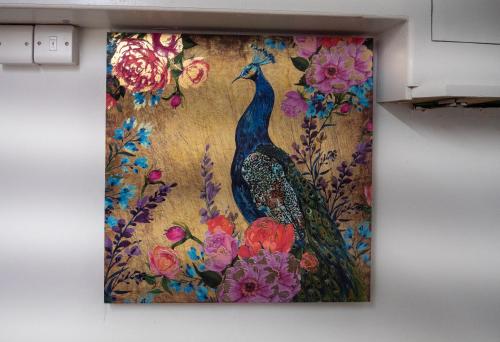 a painting of a peacock on a wall at Entire 5 Bedroom Comfortable House in Eastbourne in Eastbourne