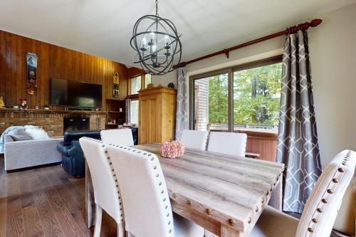 a dining room with a wooden table and white chairs at Piper Ridge B15 in Forest Farms