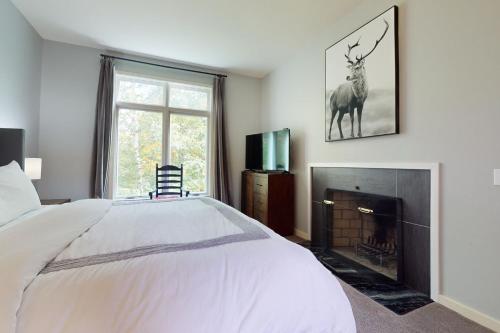 a bedroom with a white bed and a fireplace at Piper Ridge B15 in Forest Farms