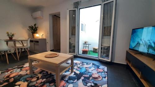 a living room with a table and a large window at Dorian in Kos Town