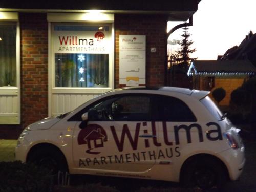 a white car parked in front of a building at Willma Apartmenthaus in Beelen