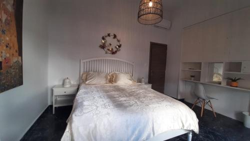 a bedroom with a white bed and a chair at Dorian in Kos Town