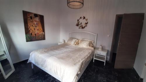 a bedroom with a white bed and a night stand at Dorian in Kos Town