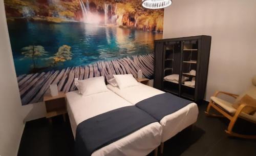 a bedroom with a bed with a painting on the wall at Dorian in Kos Town