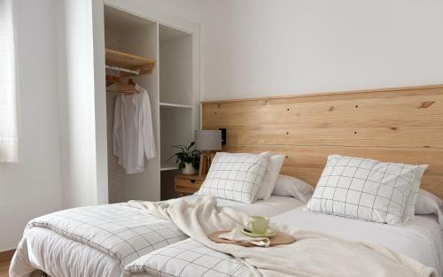 a bedroom with two beds with a tray on top of it at Cal Armengou in Castellar de NʼHug