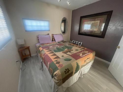 a bedroom with a bed with a quilt on it at Steam Train Hotel in Antonito