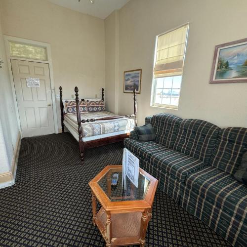 a living room with a couch and a bed at Steam Train Hotel in Antonito