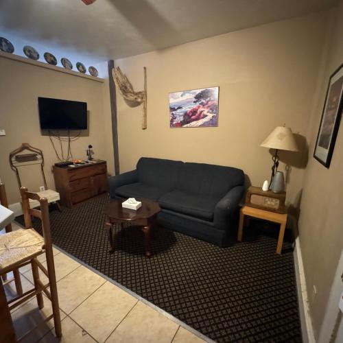 a living room with a blue couch and a table at Steam Train Hotel in Antonito