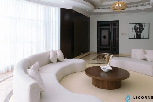 a living room with a white couch and a table at Full Moon Guesthouse in Dubai