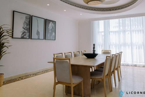 a dining room with a wooden table and chairs at Full Moon Guesthouse in Dubai