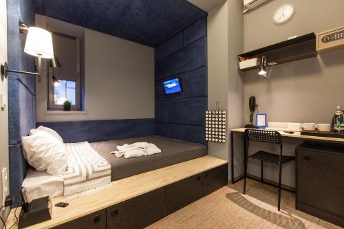 a room with a bed and a desk in it at Newport in Dnipro