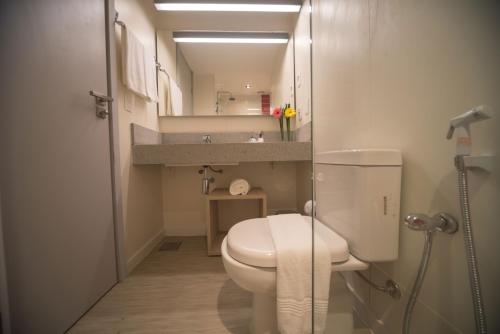 a small bathroom with a toilet and a sink at Ribalta Hotel Barra da Tijuca by Atlantica in Rio de Janeiro