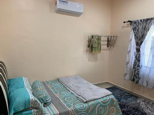 Postel nebo postele na pokoji v ubytování Teratak Annur Homestay