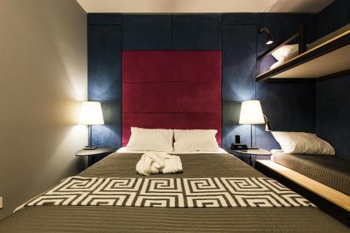 a bedroom with a large bed with two lamps at Newport in Dnipro