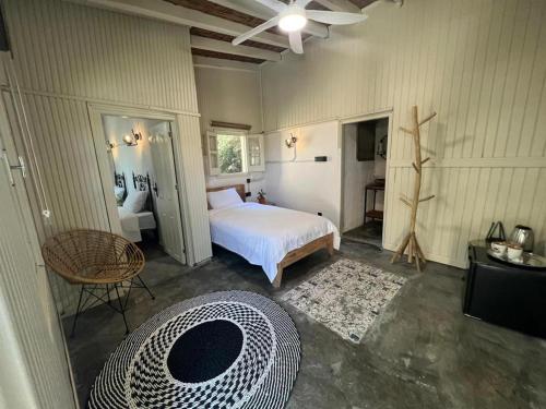 a bedroom with a bed and a table and a chair at The Old Mill Hotel Lapta in Kérynia