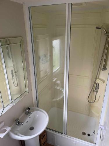 a bathroom with a shower and a sink at PG101 6 BERTH DELUXE ON THE GOLDEN PALM CHAPEL st LEONARD PG101 in Chapel Saint Leonards