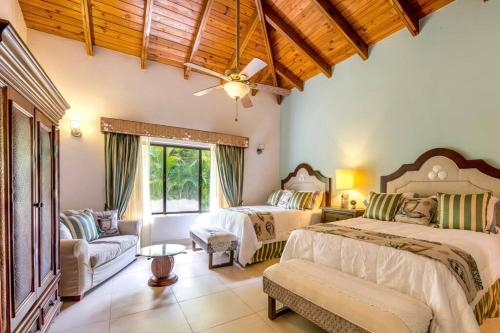 a large bedroom with two beds and a couch at Villa Cajuiles 13, Casa de Campo in La Romana