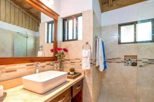 a bathroom with a sink and a shower at Villa Cajuiles 13, Casa de Campo in La Romana