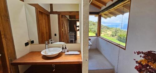 a bathroom with a sink and a large window at La Comarca de los Sueños in Sopo
