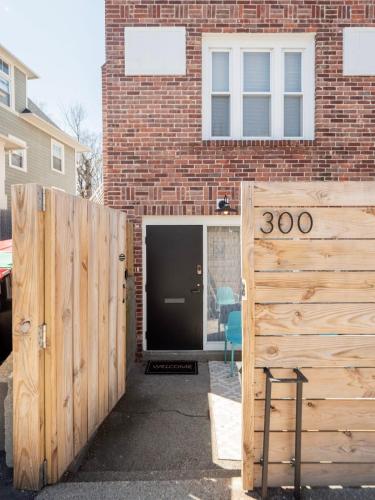a building with a wooden gate in front of a building at Jennifer's College Hill Apartment Private Entry & Patio in Providence