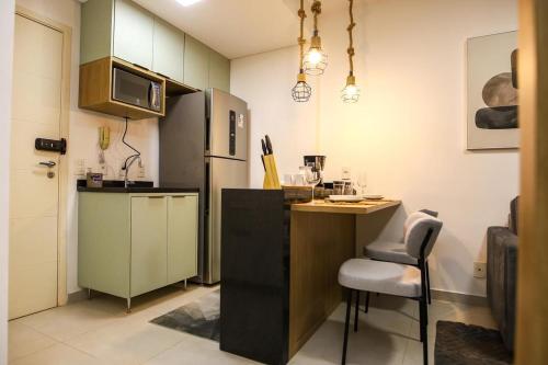 a small kitchen with a counter and a refrigerator at FLATS - DUO JK in Sao Jose do Rio Preto