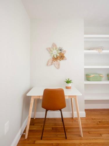 a table and a chair in a room at Jennifer's College Hill Apartment Close to Everything in Providence