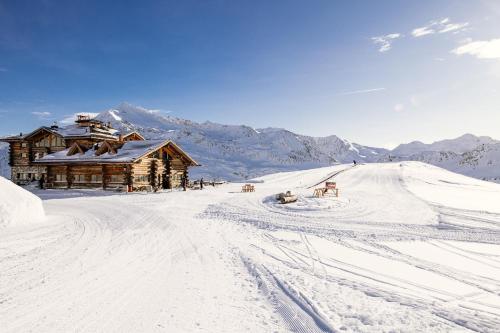a ski lodge on a snow covered mountain with a road at Hotel Nordik in Santa Caterina Valfurva