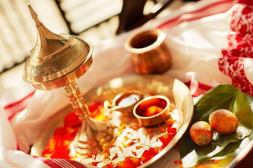 a table topped with a plate of food with a pot of food at Vivanta Guwahati in Guwahati